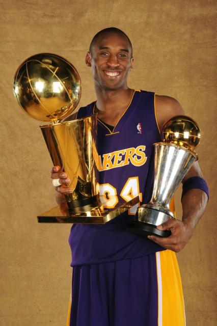 Kobe Bryant poses with both Larry O_Brien trophy and his 2009 NBA Finals MVP trophy